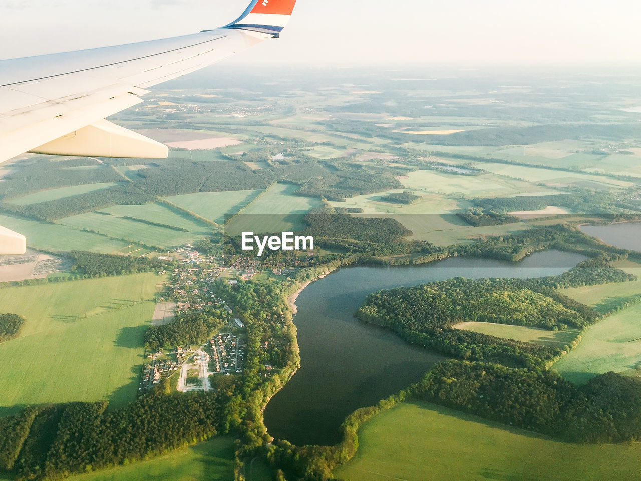 Cropped image of airplane flying over landscape