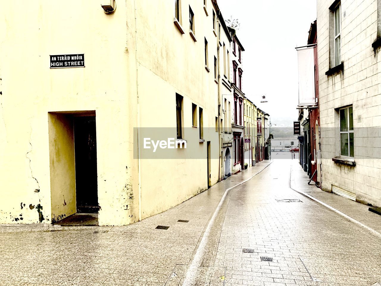 EMPTY ROAD ALONG BUILDINGS