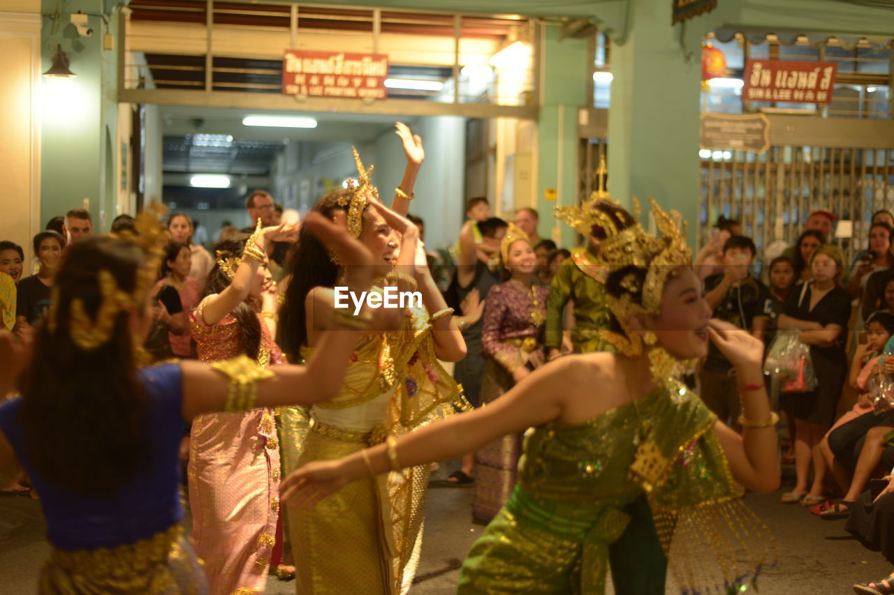 GROUP OF PEOPLE DANCING IN MARKET