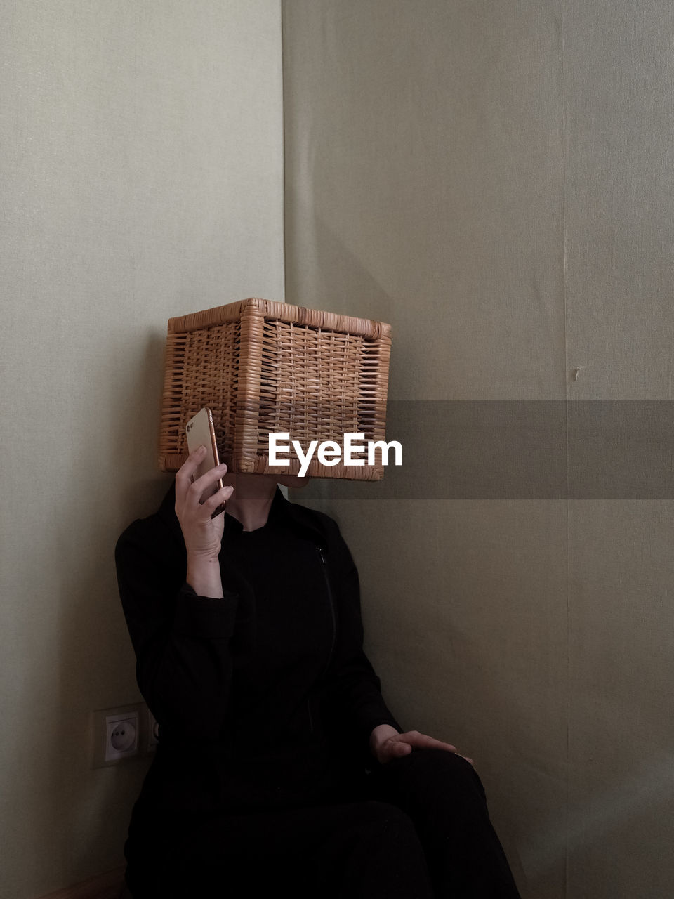 Woman with obscured face using mobile phone