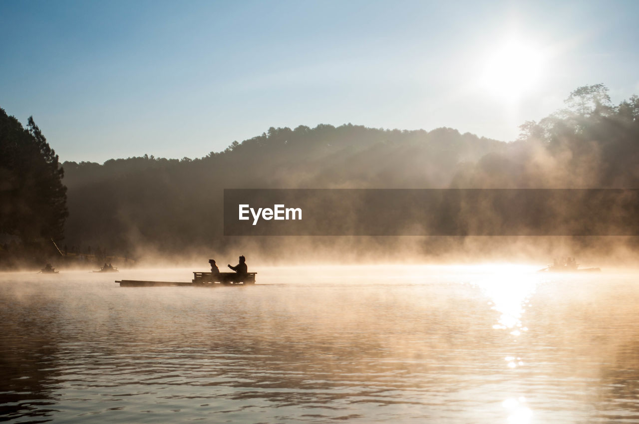 Scenic view of lake against sky during foggy weather