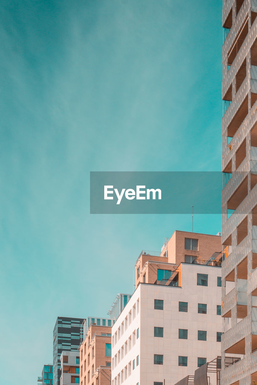 Low angle view of buildings against blue sky