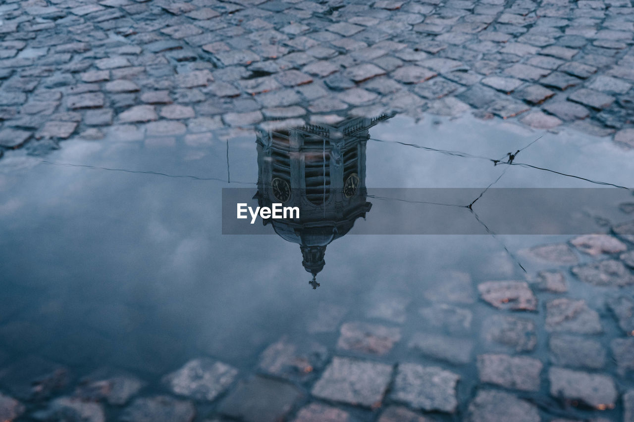 REFLECTION OF BUILDINGS IN PUDDLE