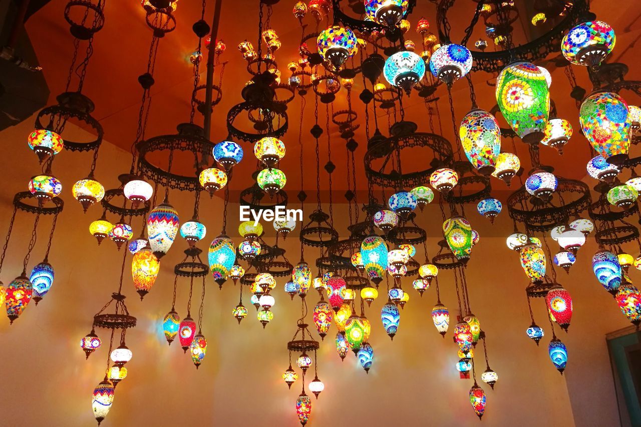 Low angle view of illuminated lanterns hanging from ceiling