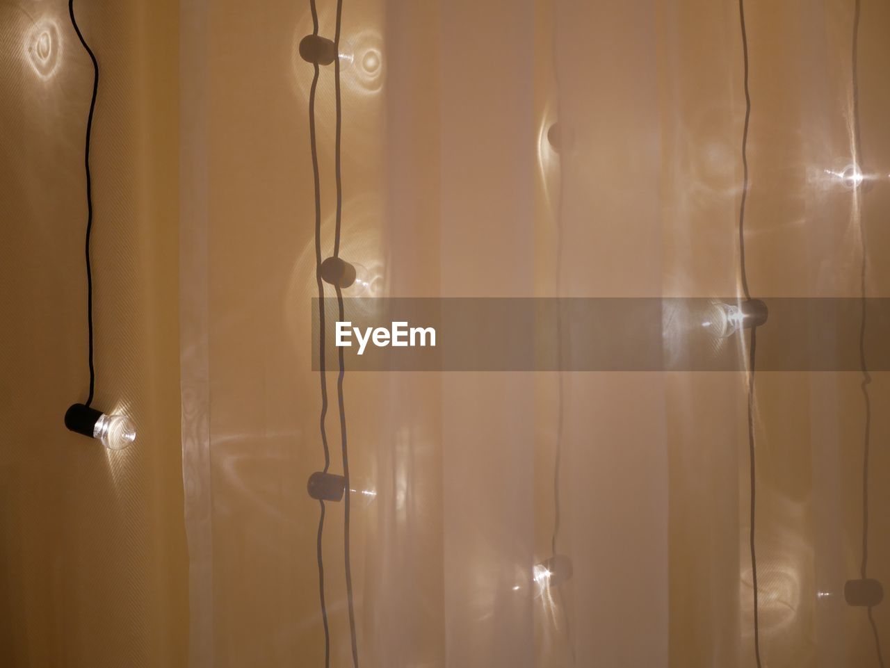 CLOSE-UP OF ILLUMINATED LIGHTING EQUIPMENT ON WALL