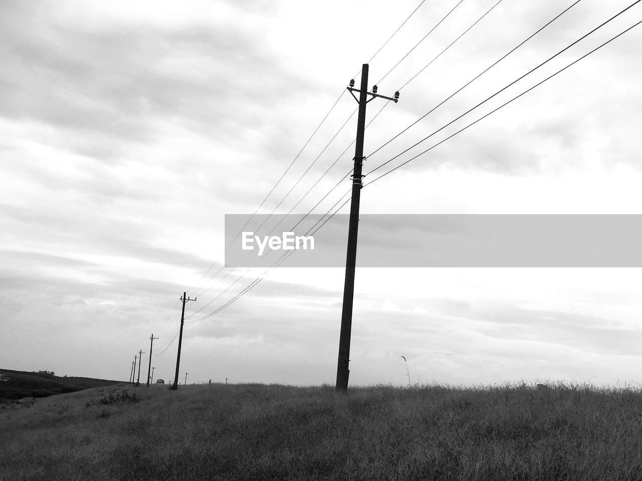 LOW ANGLE VIEW OF POWER LINES AGAINST SKY