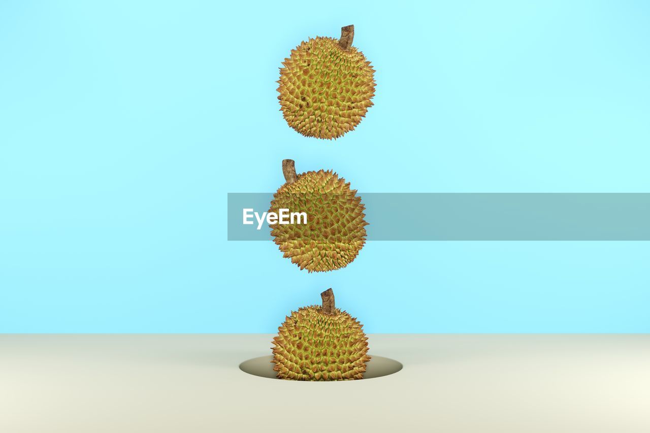 Digital composite image of durian over colored background