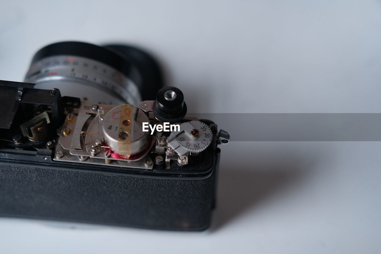 Close-up of camera on table against white background