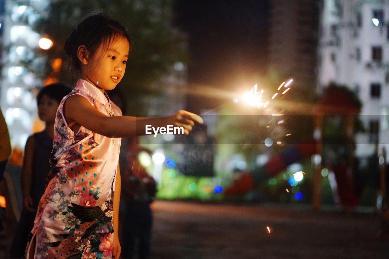 Young girl holding sparkler