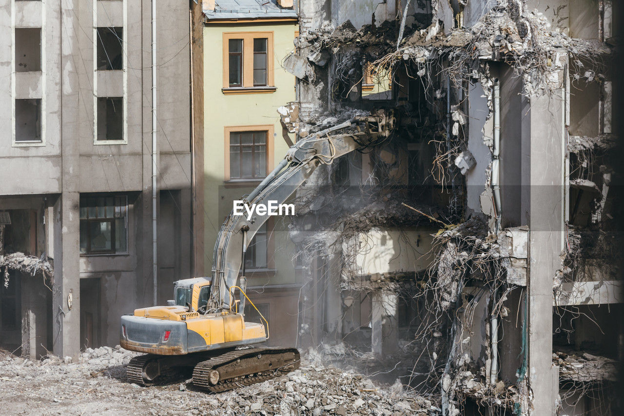 Destroyed building, demolition of a building, house ruins, reconstruction, excavator-destroyer