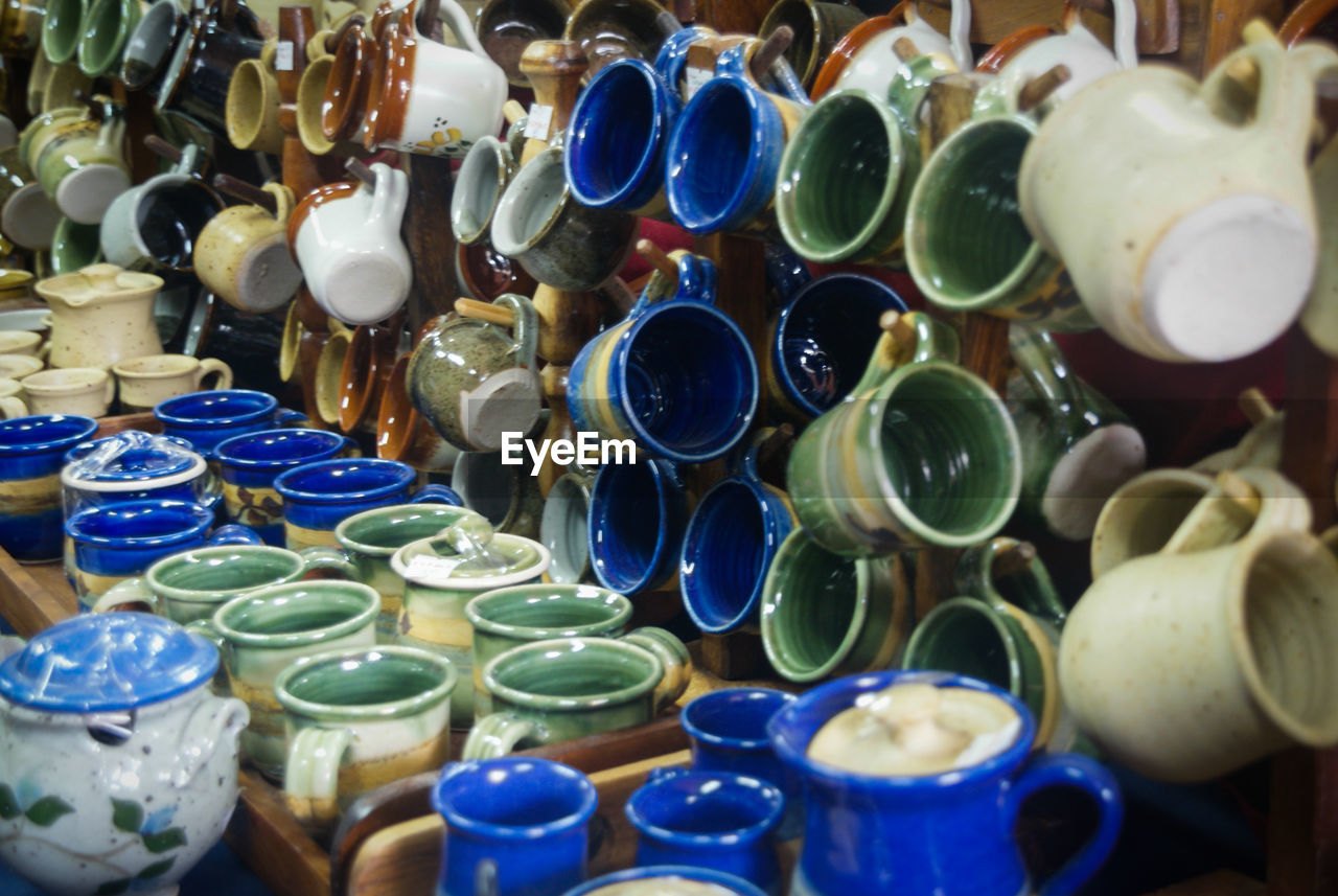 Close-up of various cups displayed for sale