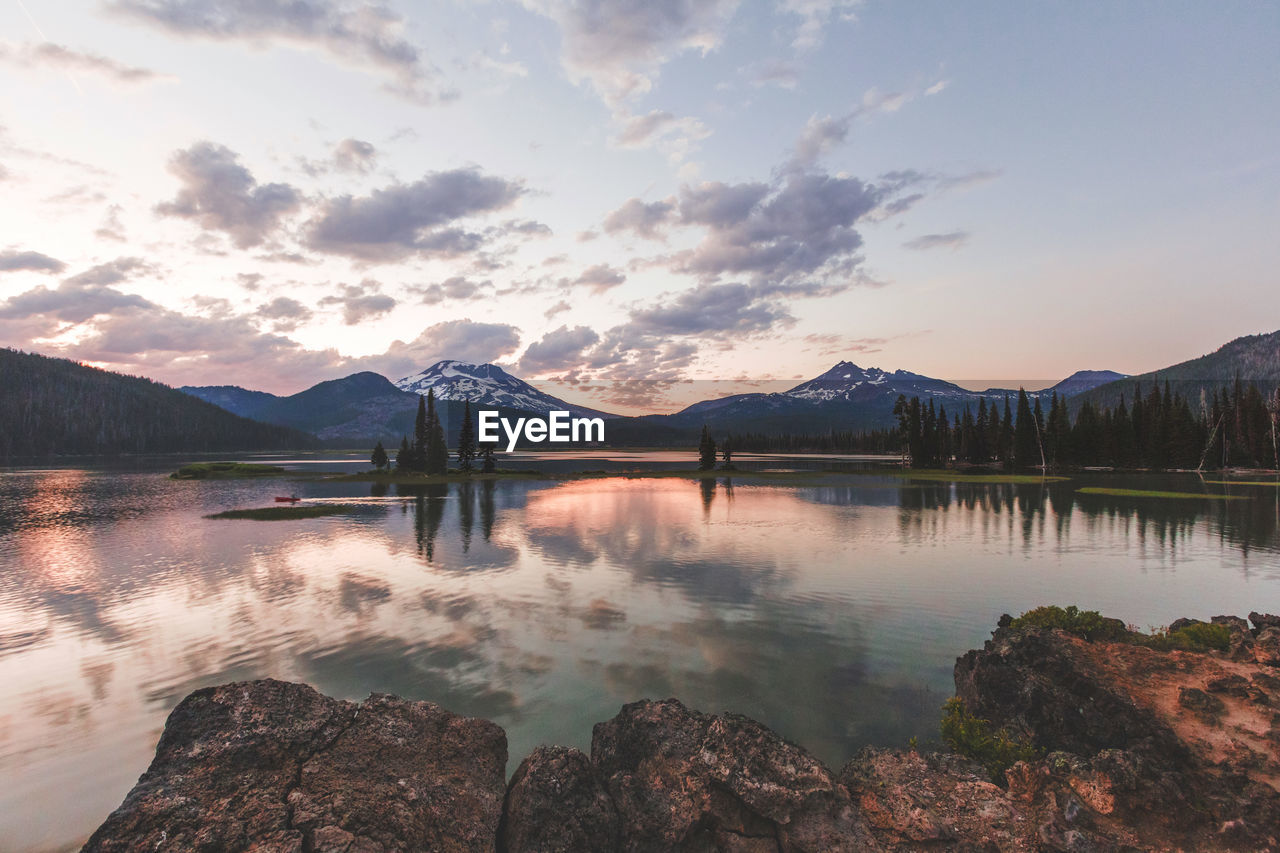 Scenic view of calm lake against sky during sunset