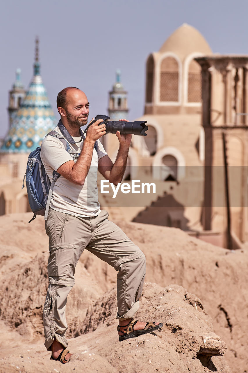 Man with camera at historic place