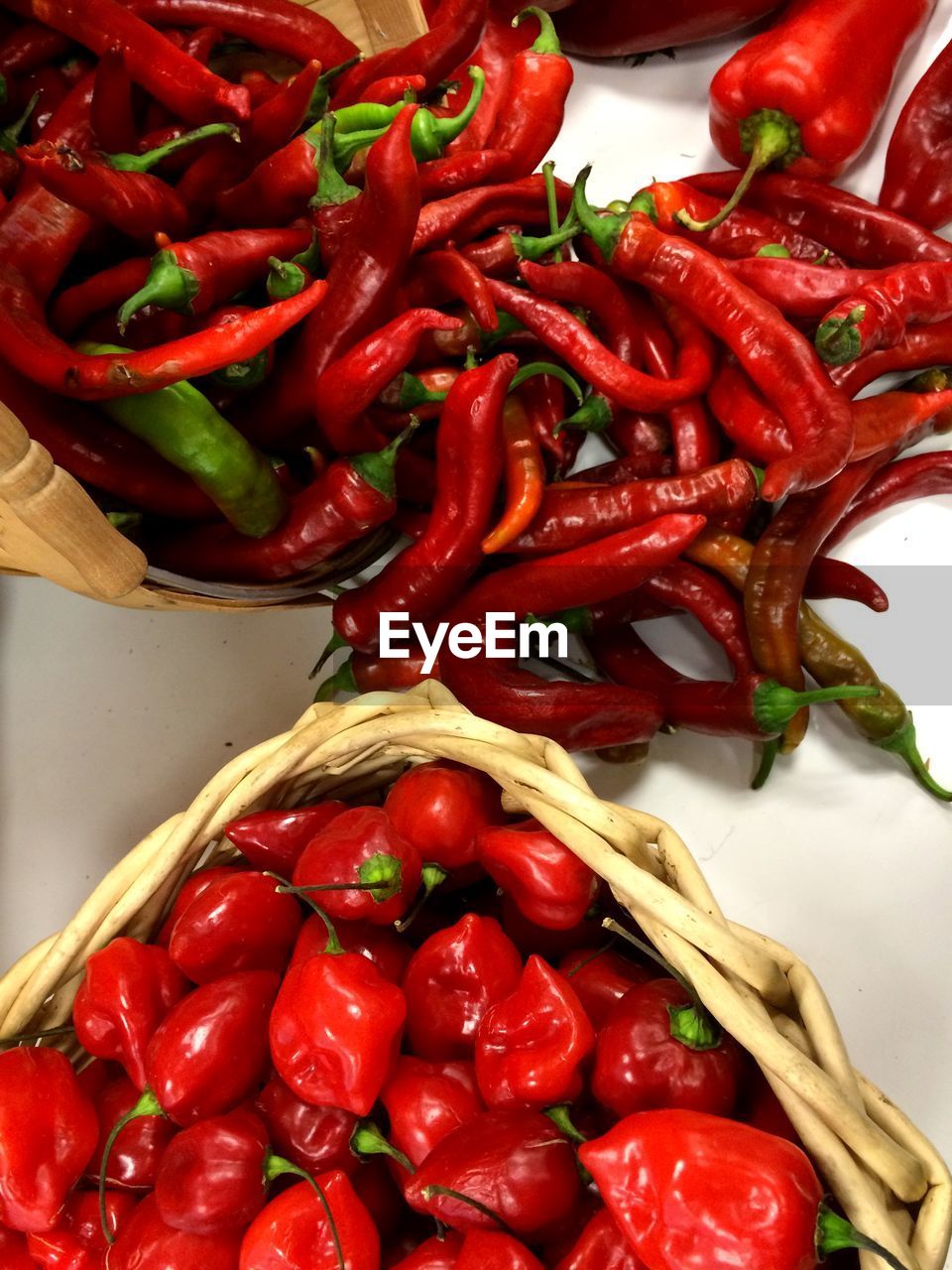 Red chili peppers in baskets on table