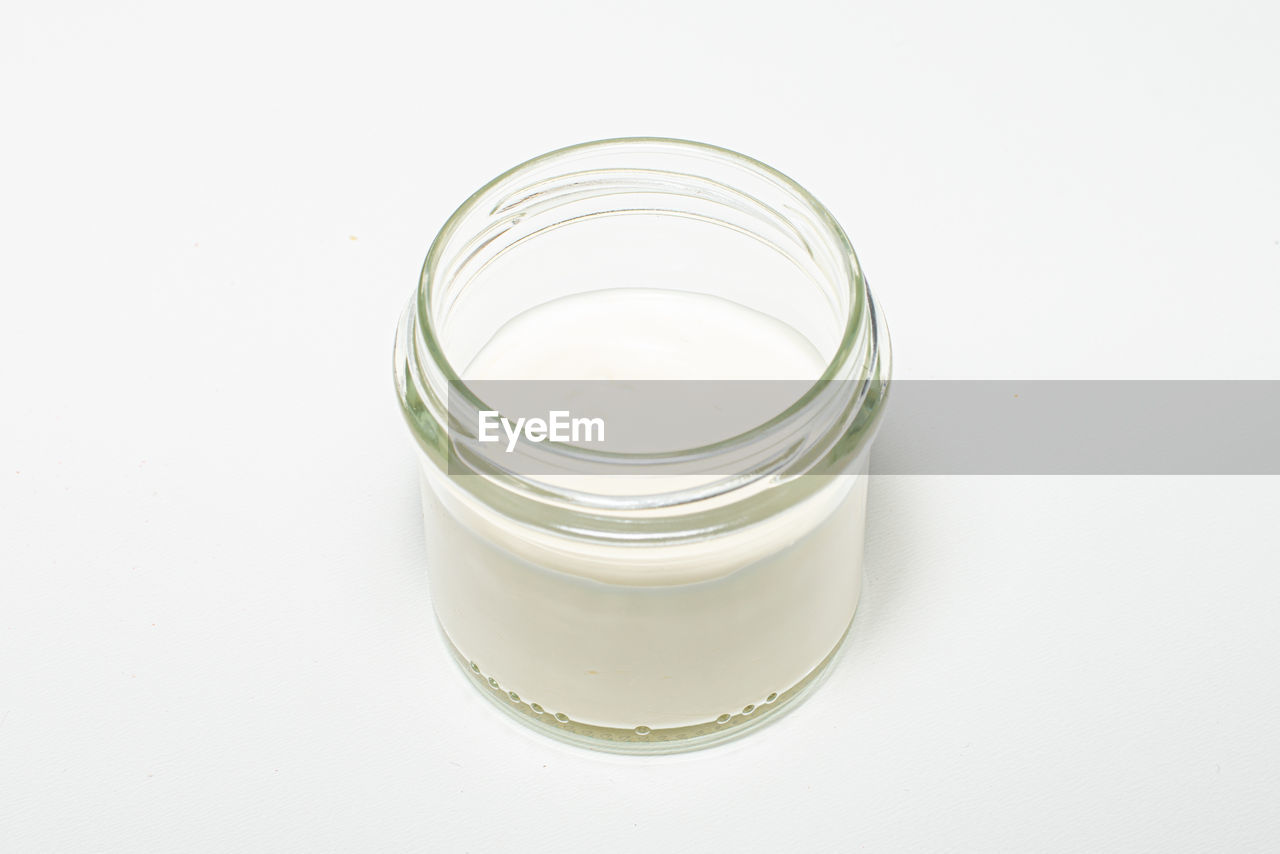 HIGH ANGLE VIEW OF GLASS OF WHITE JAR