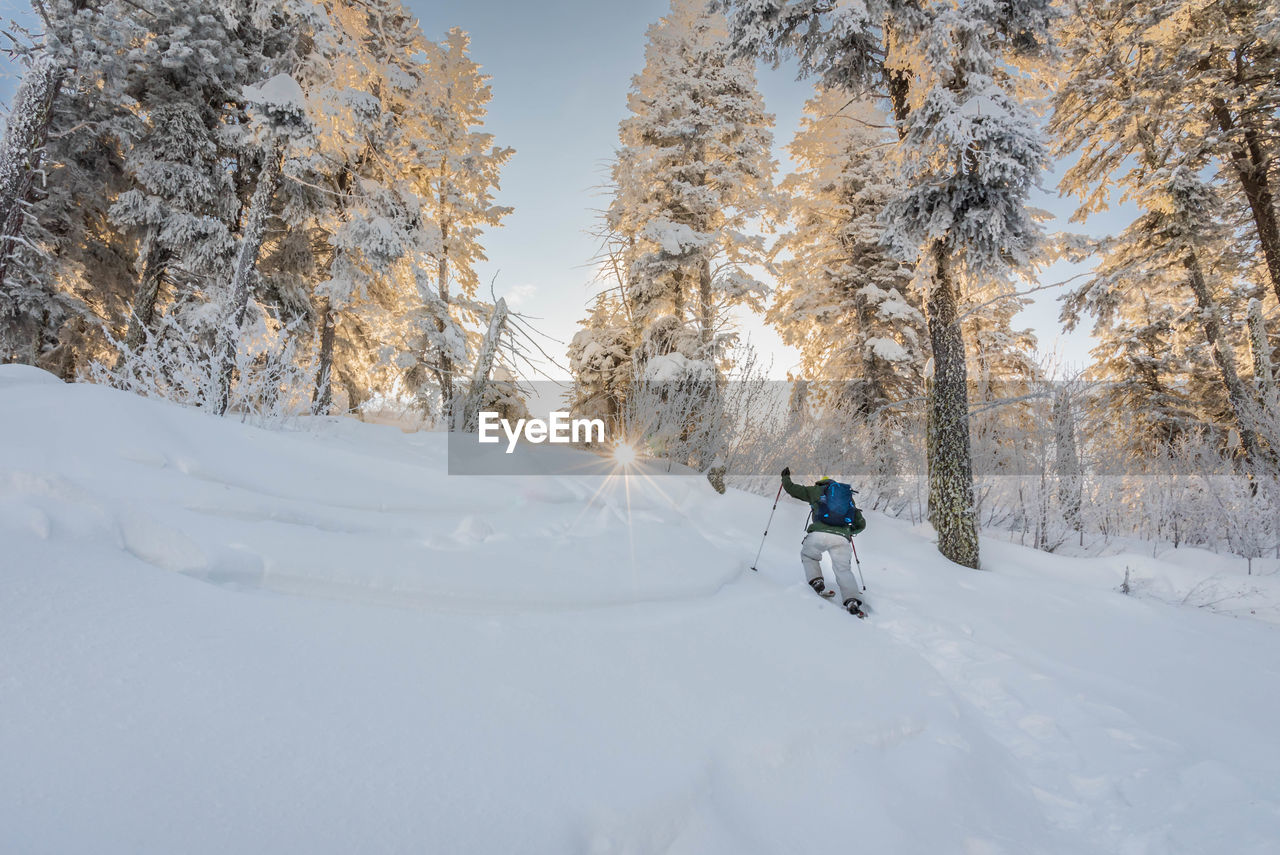 Rear view of man skiing on snow