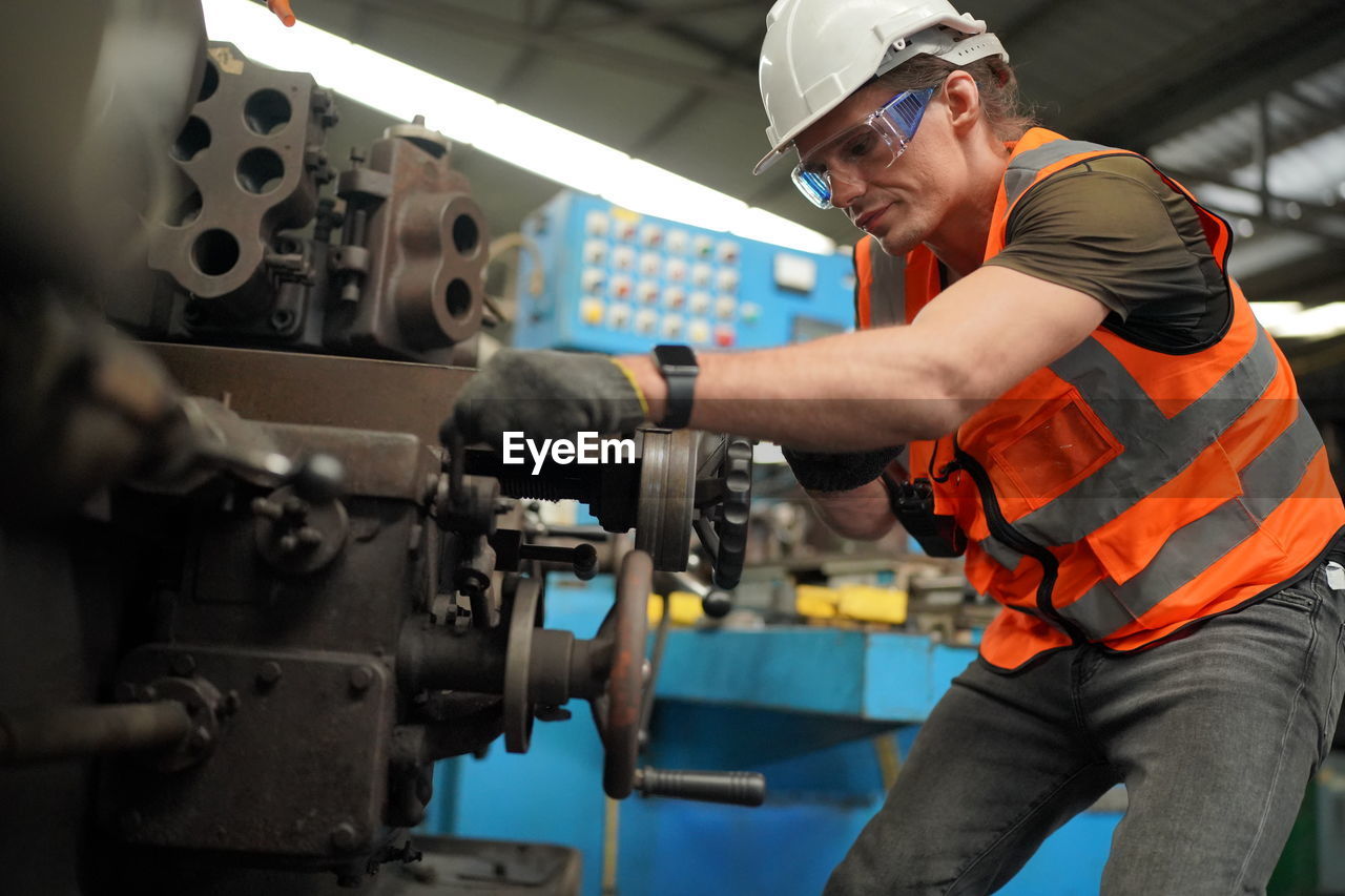 Portrait of male worker standing in the heavy industry manufacturing factory.