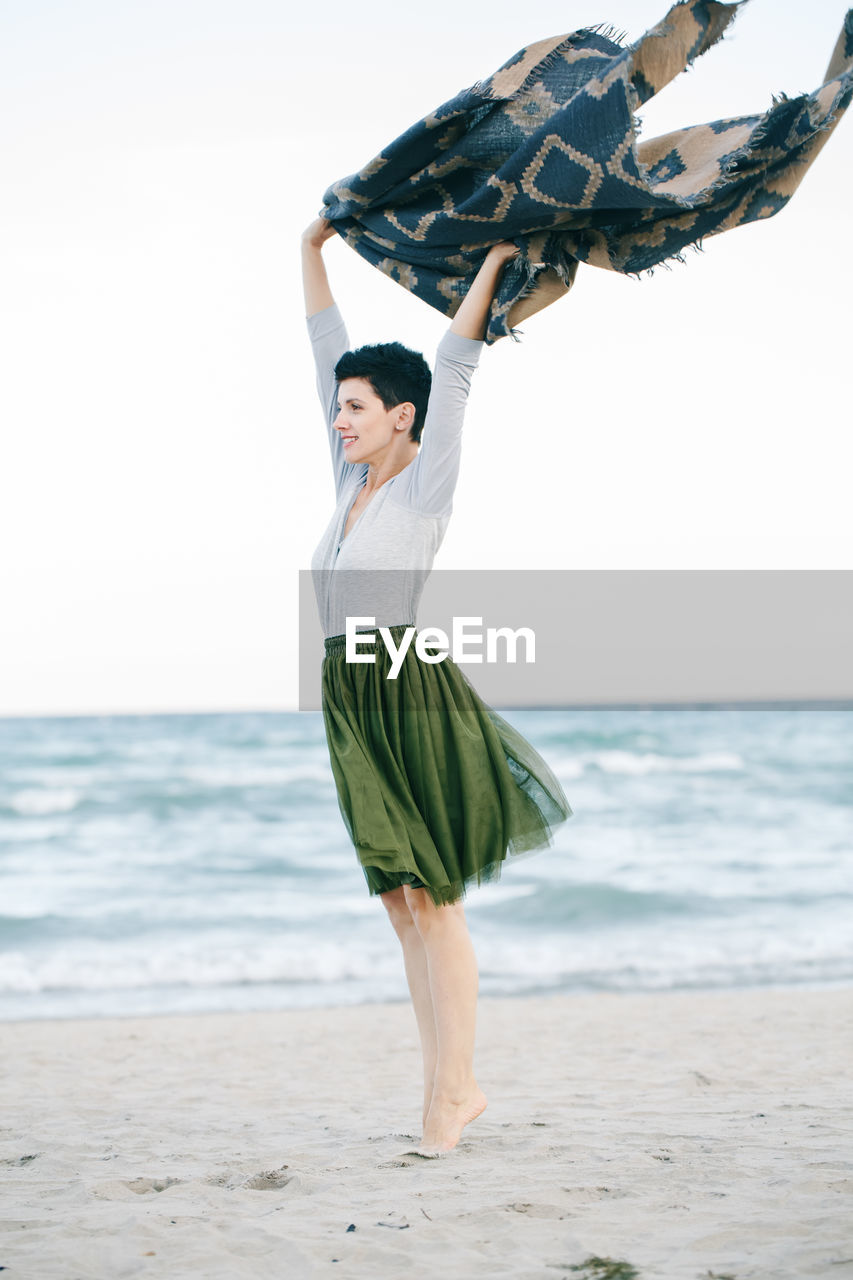 Woman standing on sand at beach