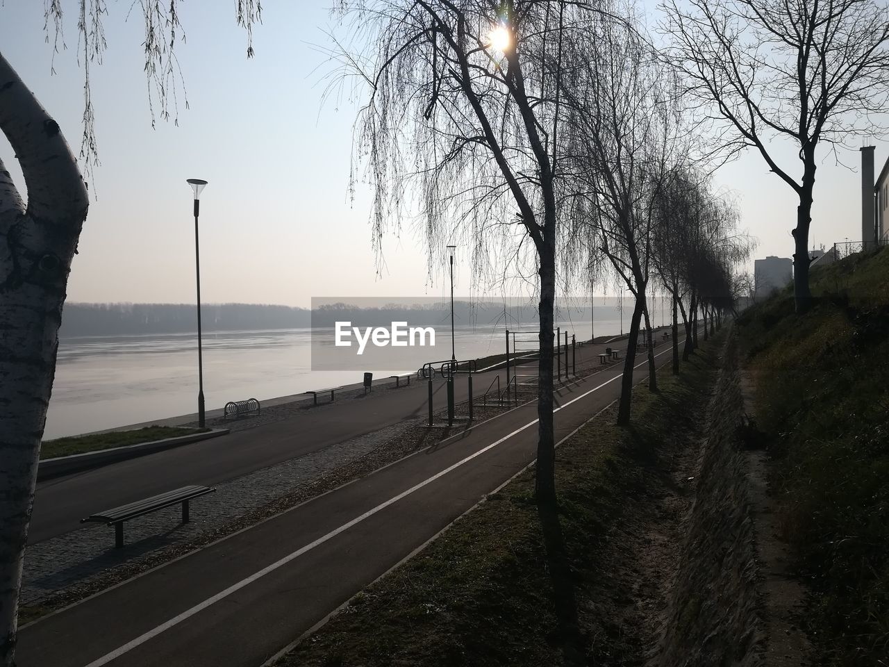 ROAD BY RIVER AGAINST SKY