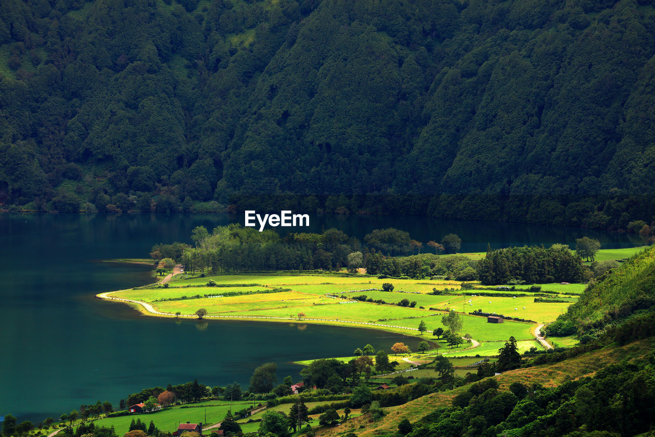 Scenic view of lake by landscape against mountain