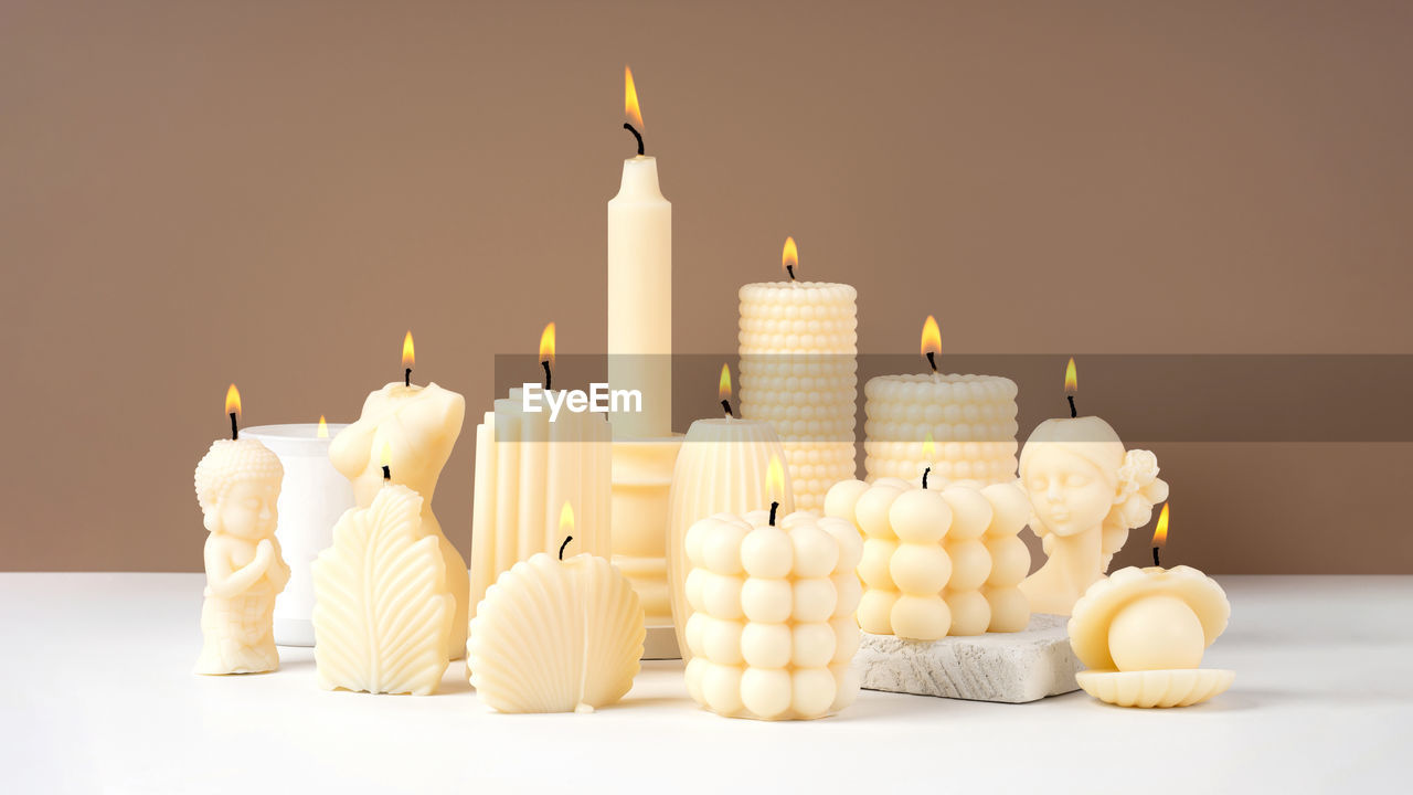 Holiday decorations on table. a set of  handmade wax candle on a neutral background. copy space