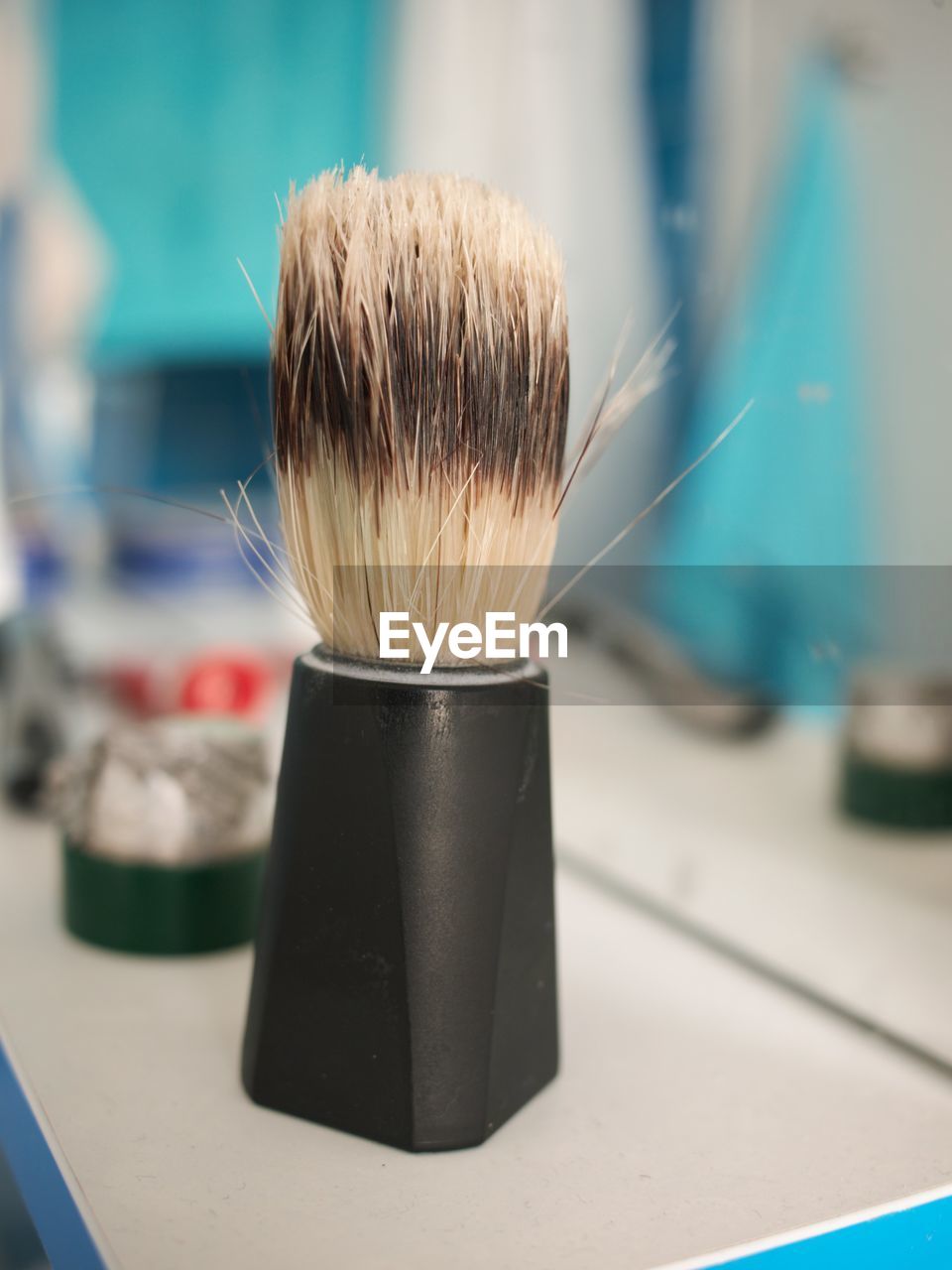 Close-up of shaving brush in bathroom