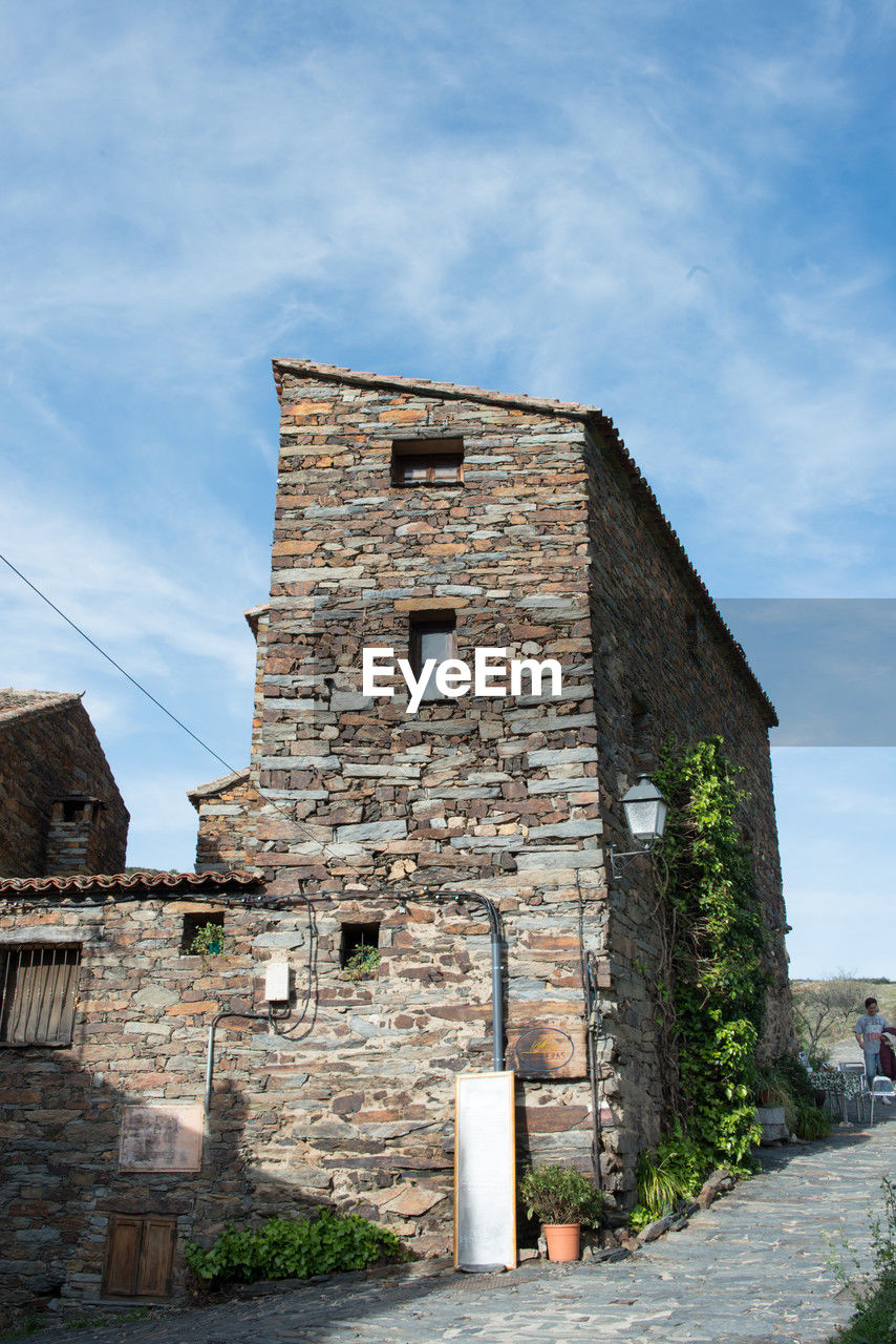 architecture, built structure, building exterior, sky, history, building, the past, nature, village, old, town, cloud, wall, ruins, house, travel destinations, no people, city, day, outdoors, stone material, rural area, travel, street, tower, blue, brick, tourism, ancient