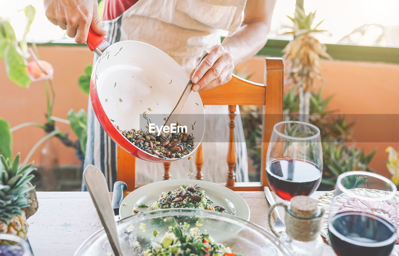 Midsection of man preparing food on table