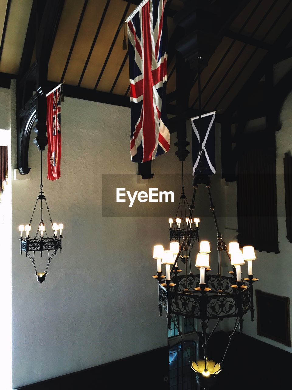 British flags and illuminated chandelier hanging in room