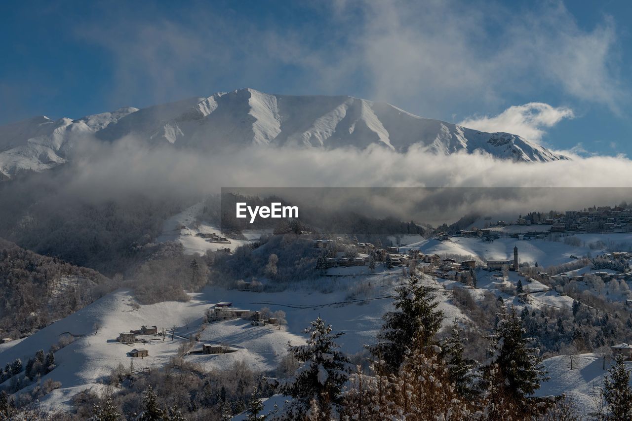 Scenic view of snowcapped mountains against sky