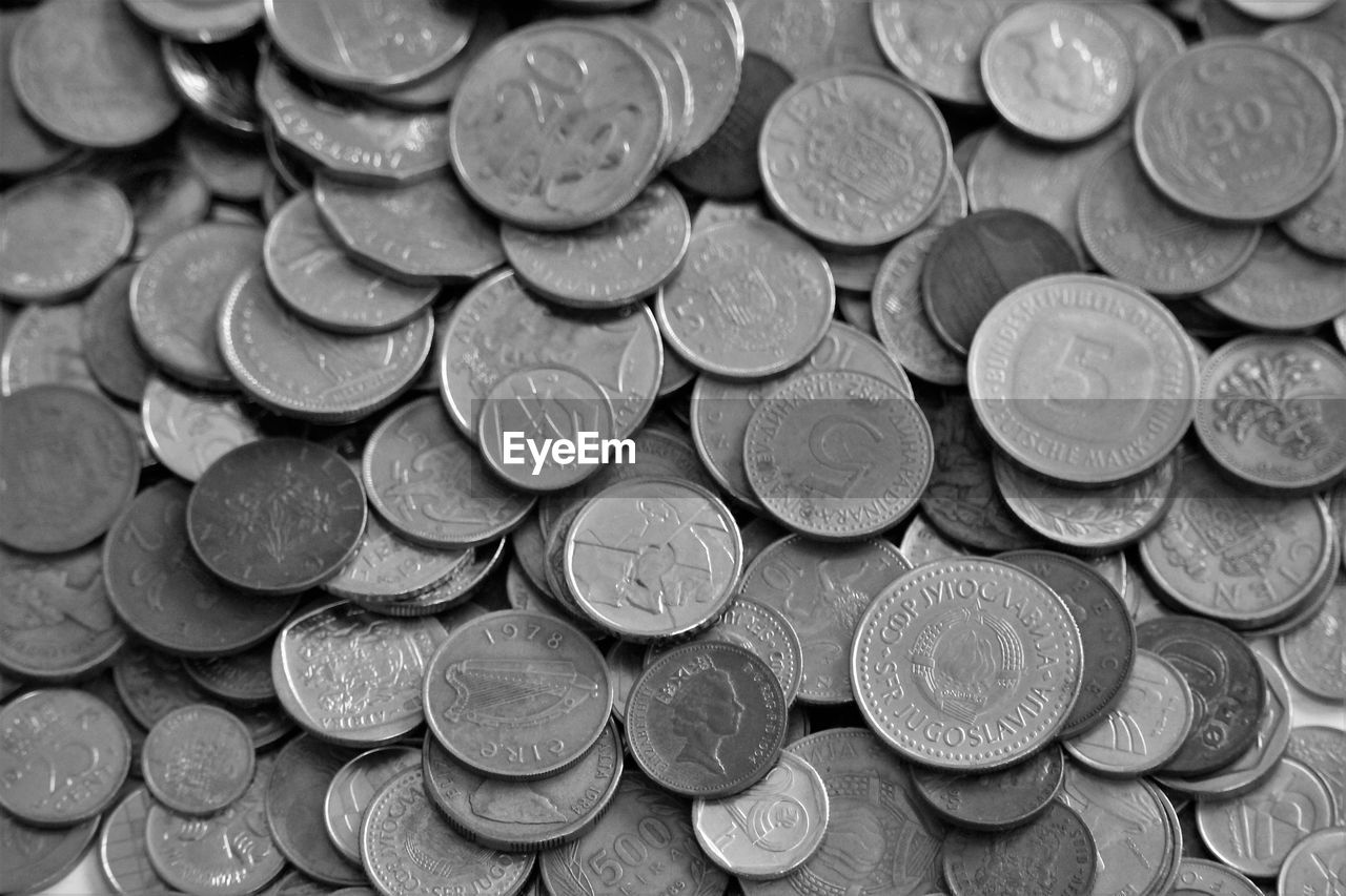 FULL FRAME SHOT OF COINS ON METAL