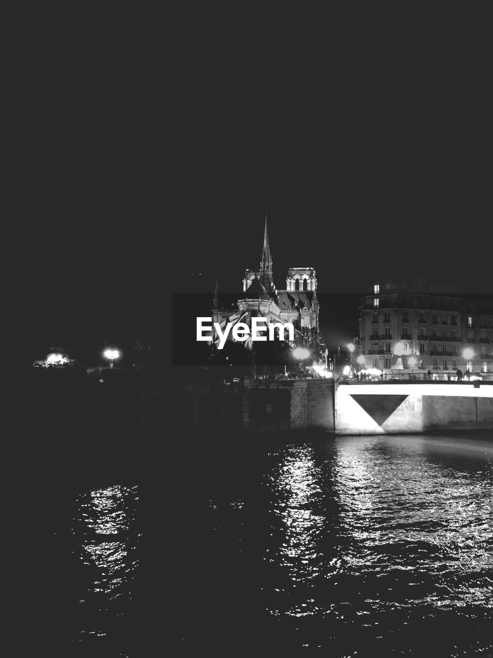 View of illuminated buildings from across river