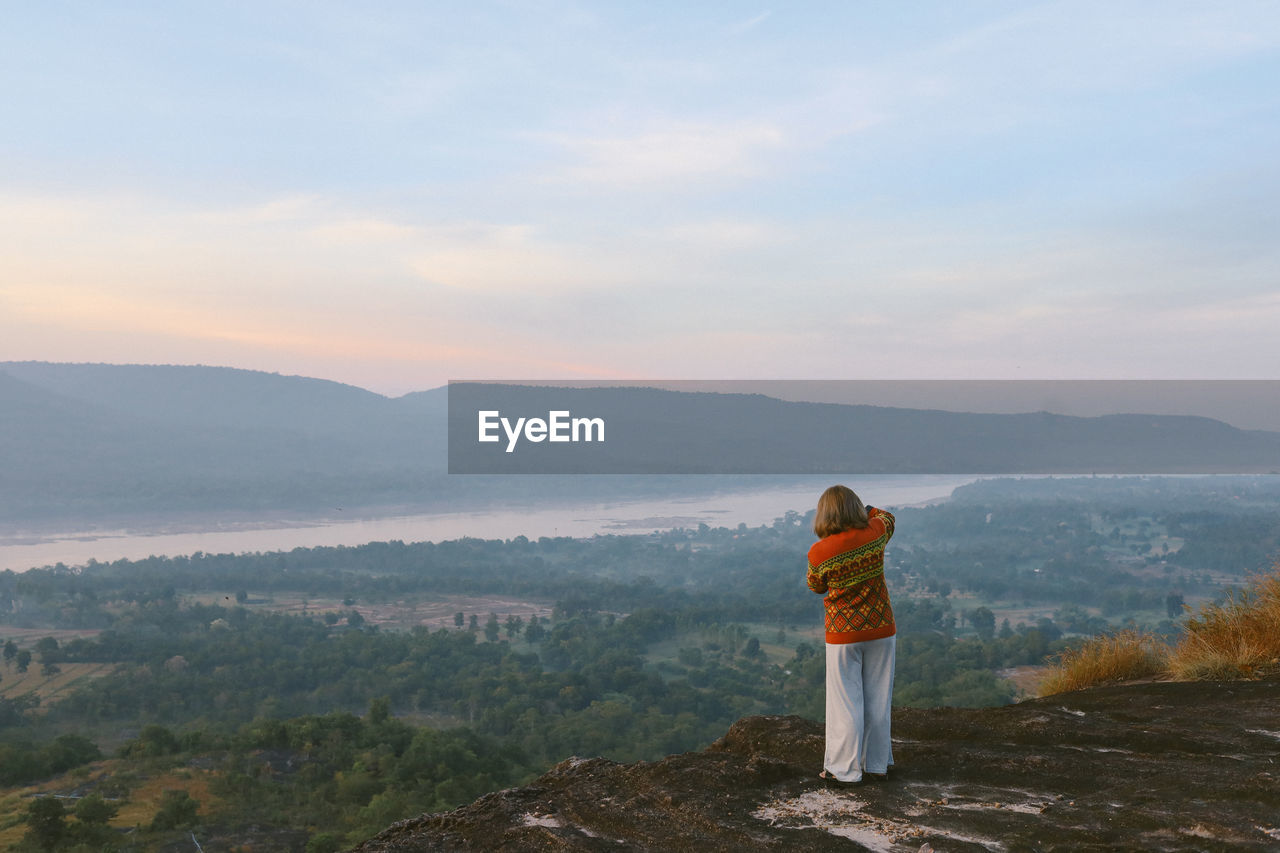 Rear view of girl standing on mountain