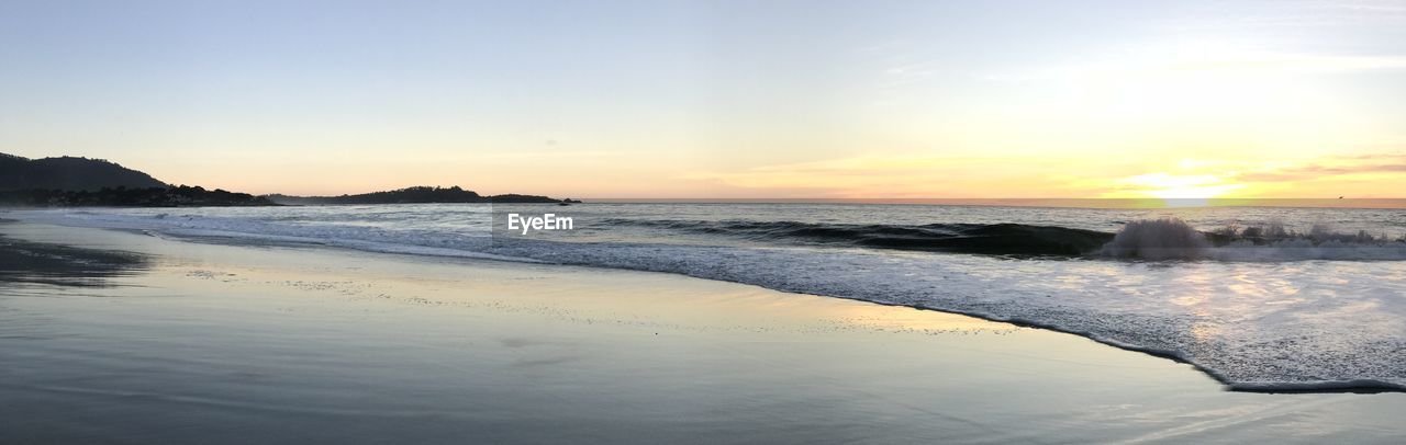 SCENIC VIEW OF BEACH DURING SUNSET