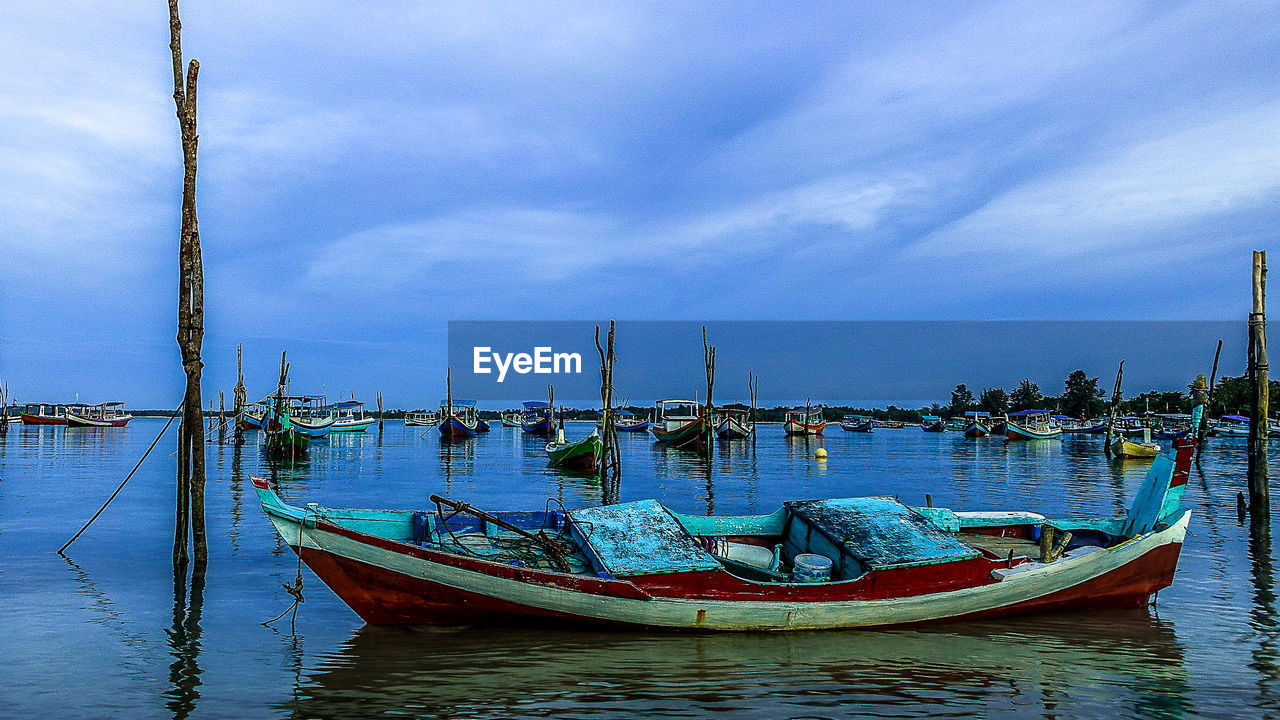 FISHING BOATS MOORED IN SEA