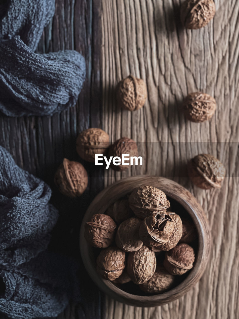 Walnut in a wooden bowl and on the wooden table