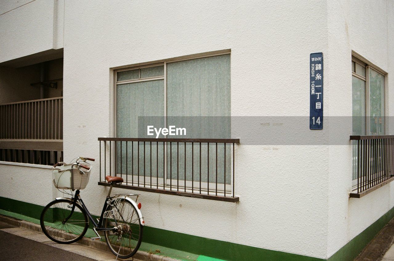 Bicycle parked by the window on corner