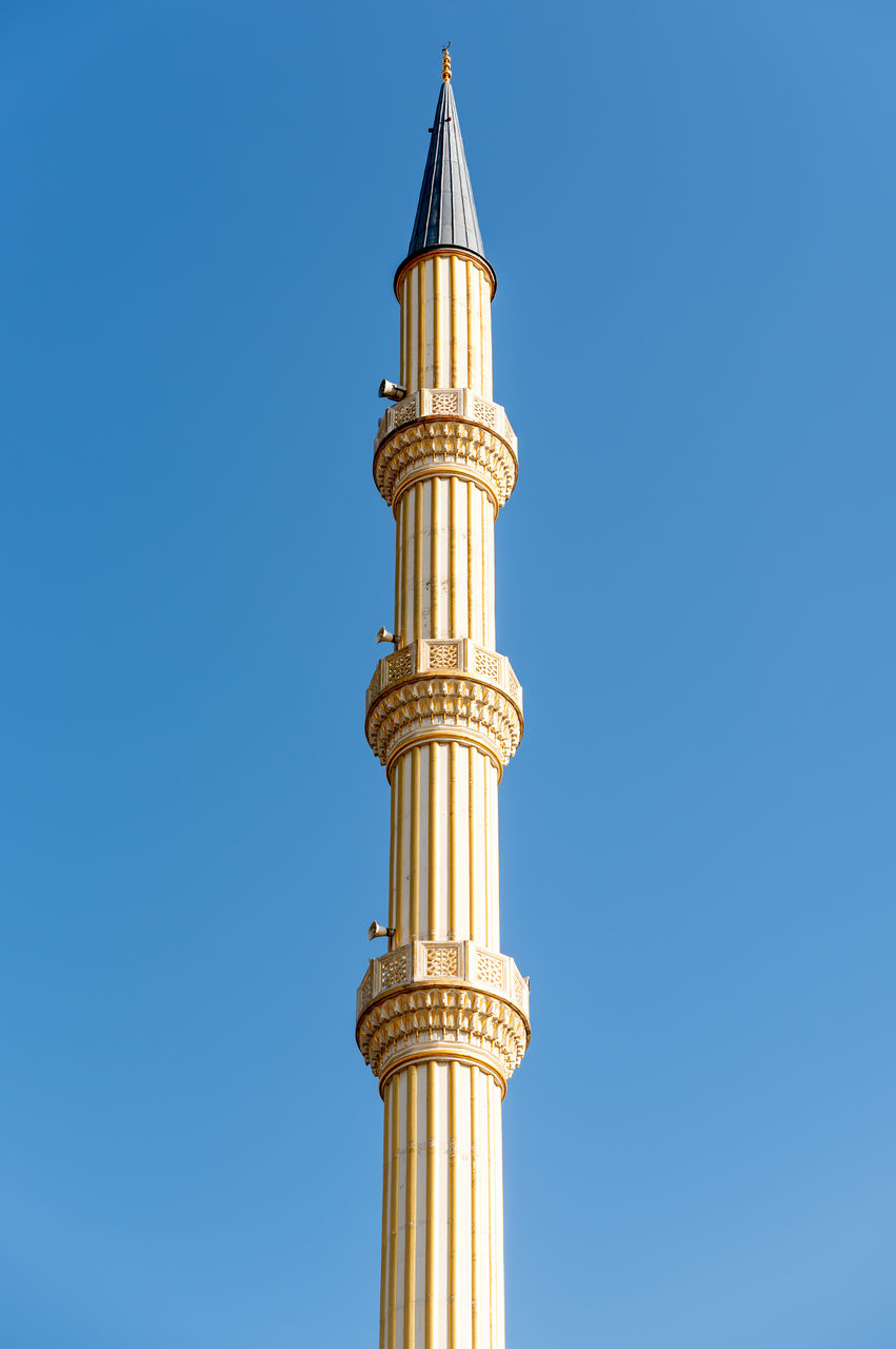 low angle view of column against clear blue sky