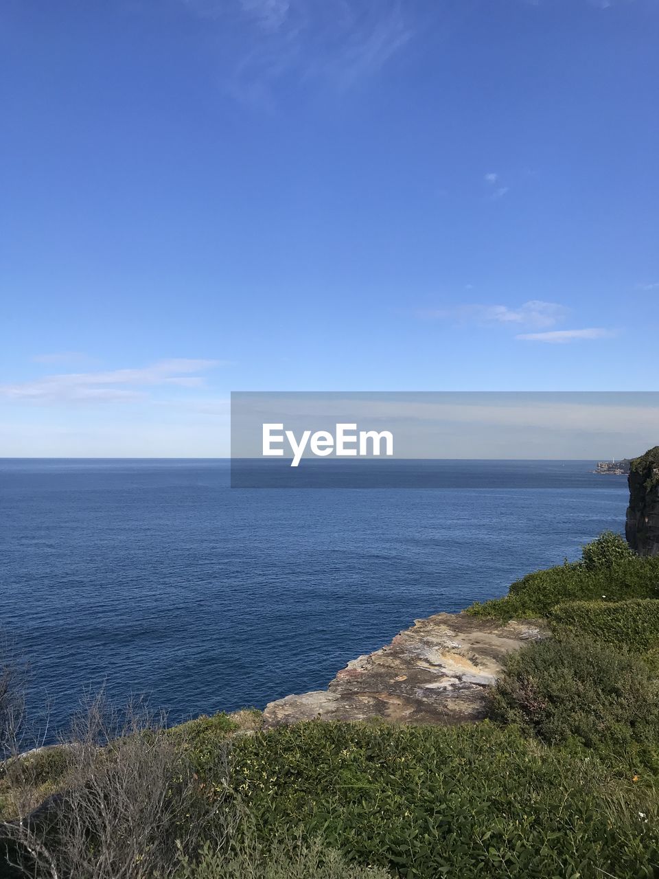 Scenic view of sea against blue sky