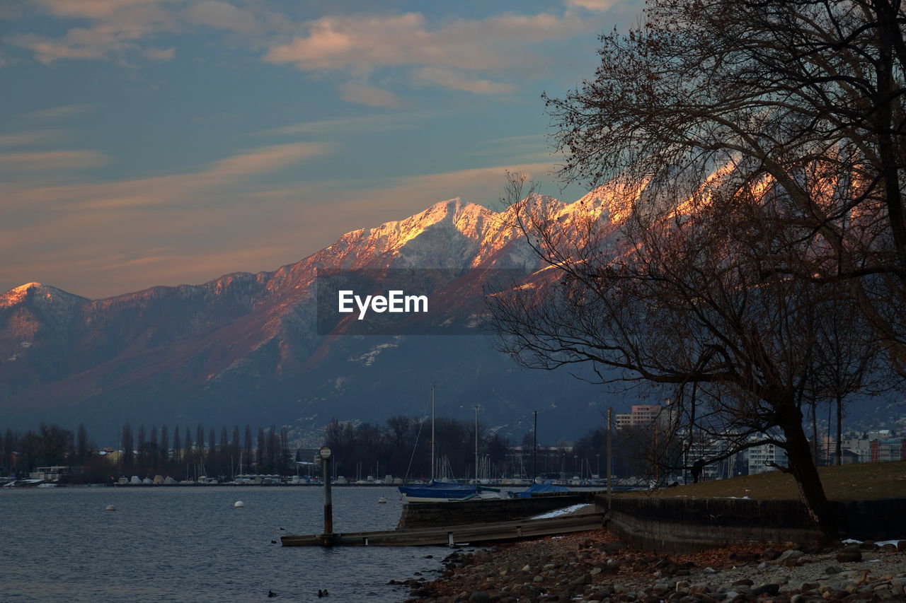 Scenic view of lake against sky during sunset