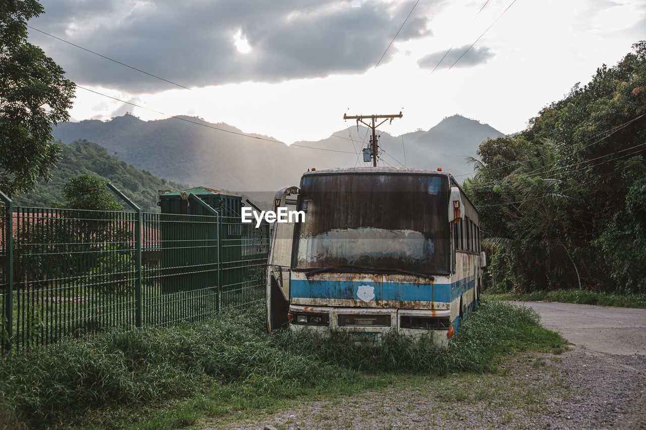 BUILT STRUCTURE ON FIELD AGAINST MOUNTAINS