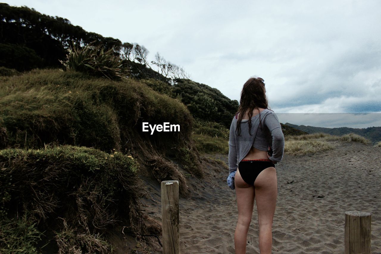 Full length of woman standing on beach