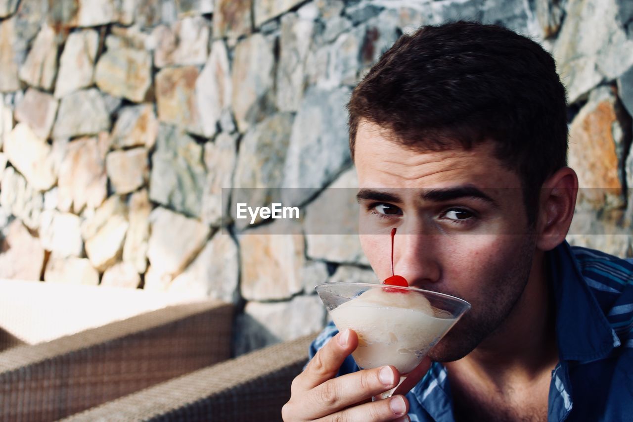 Portrait of man having drink in restaurant