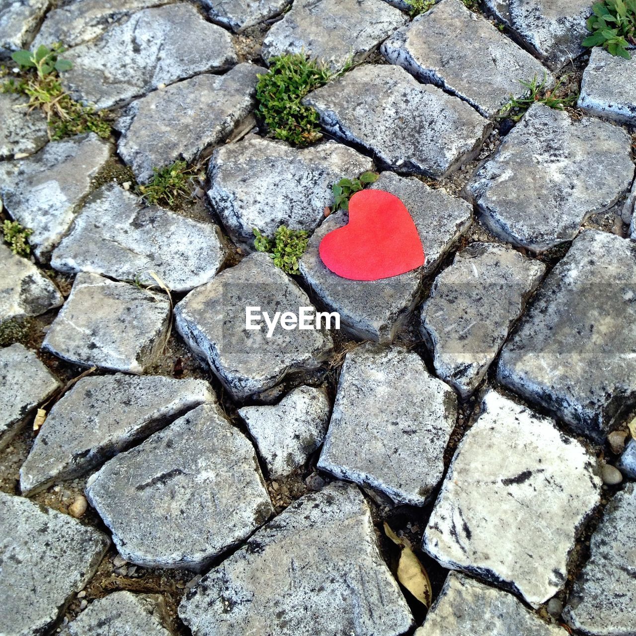 High angle view of red heart shape on footpath