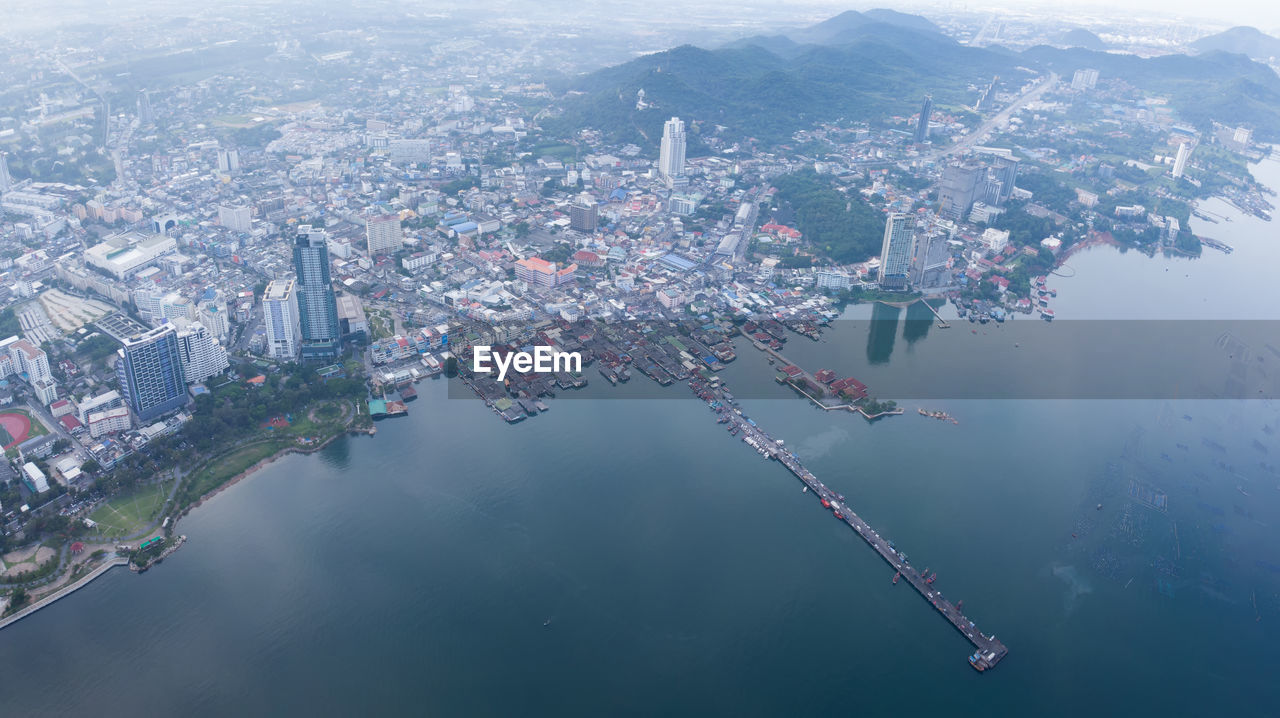 Aerial view of buildings by sea in city