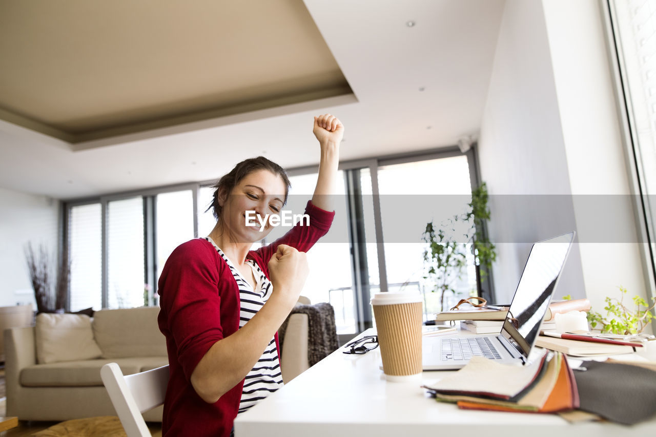 Happy woman at desk at home