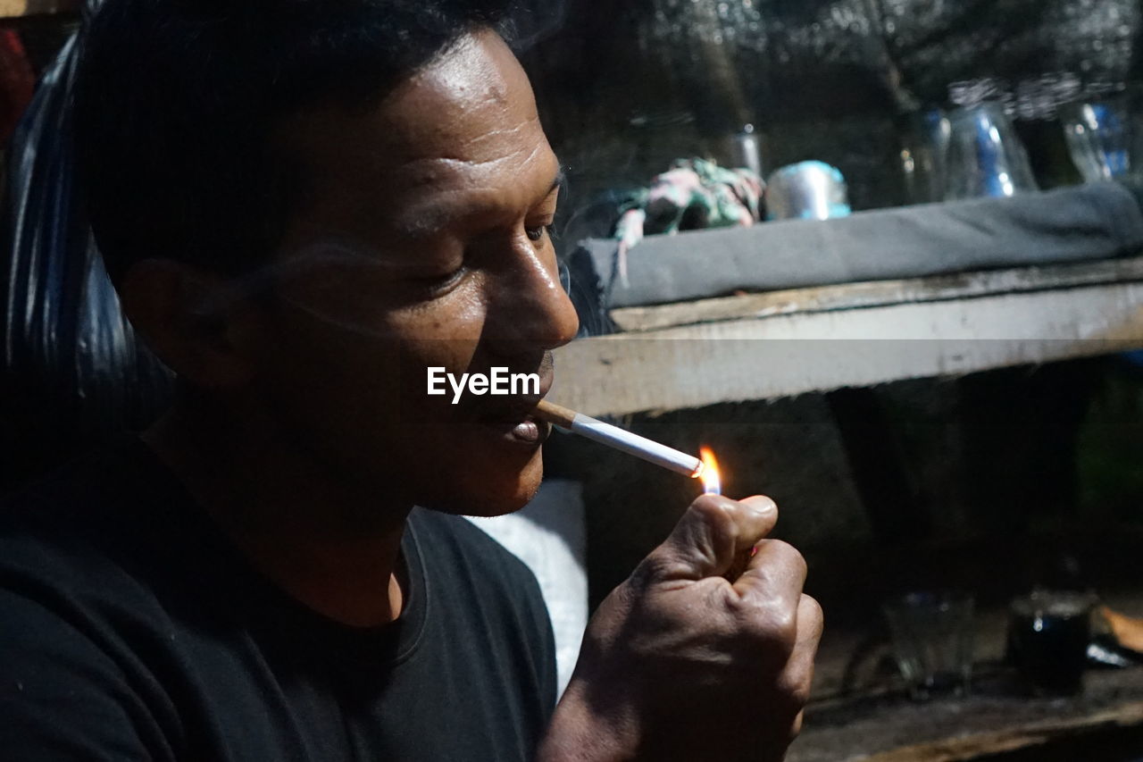 Portrait of man smoking cigarette