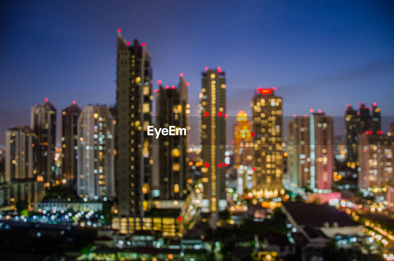 ILLUMINATED BUILDINGS IN CITY AT NIGHT