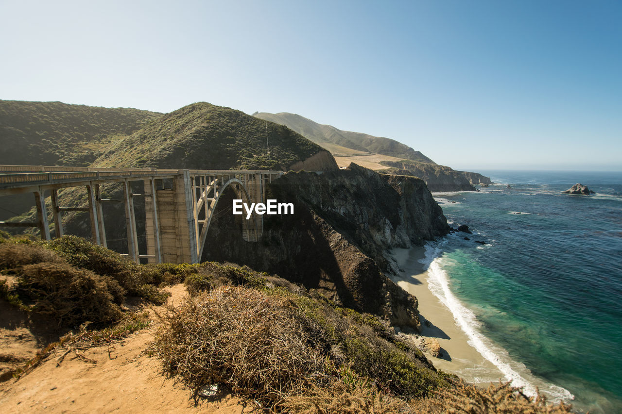 Scenic view of bixby creek bridge by sea against sky at big sur