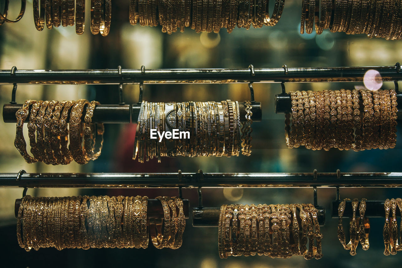 Close-up of bangles hanging on rack in shop